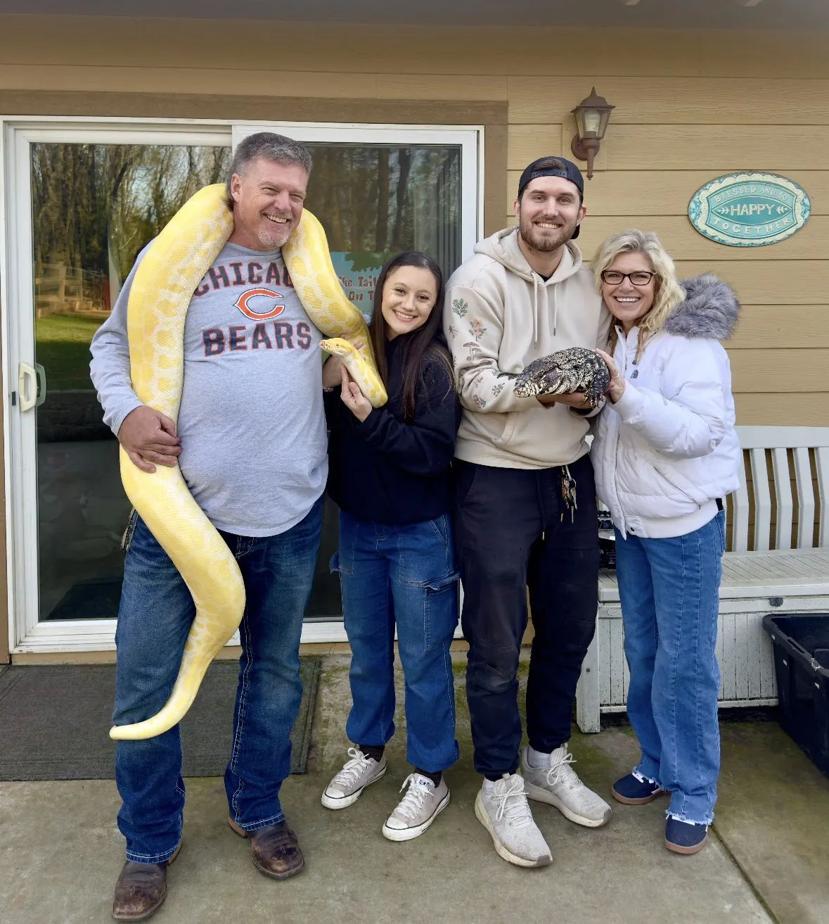 A family on a porch sharing a yellow python