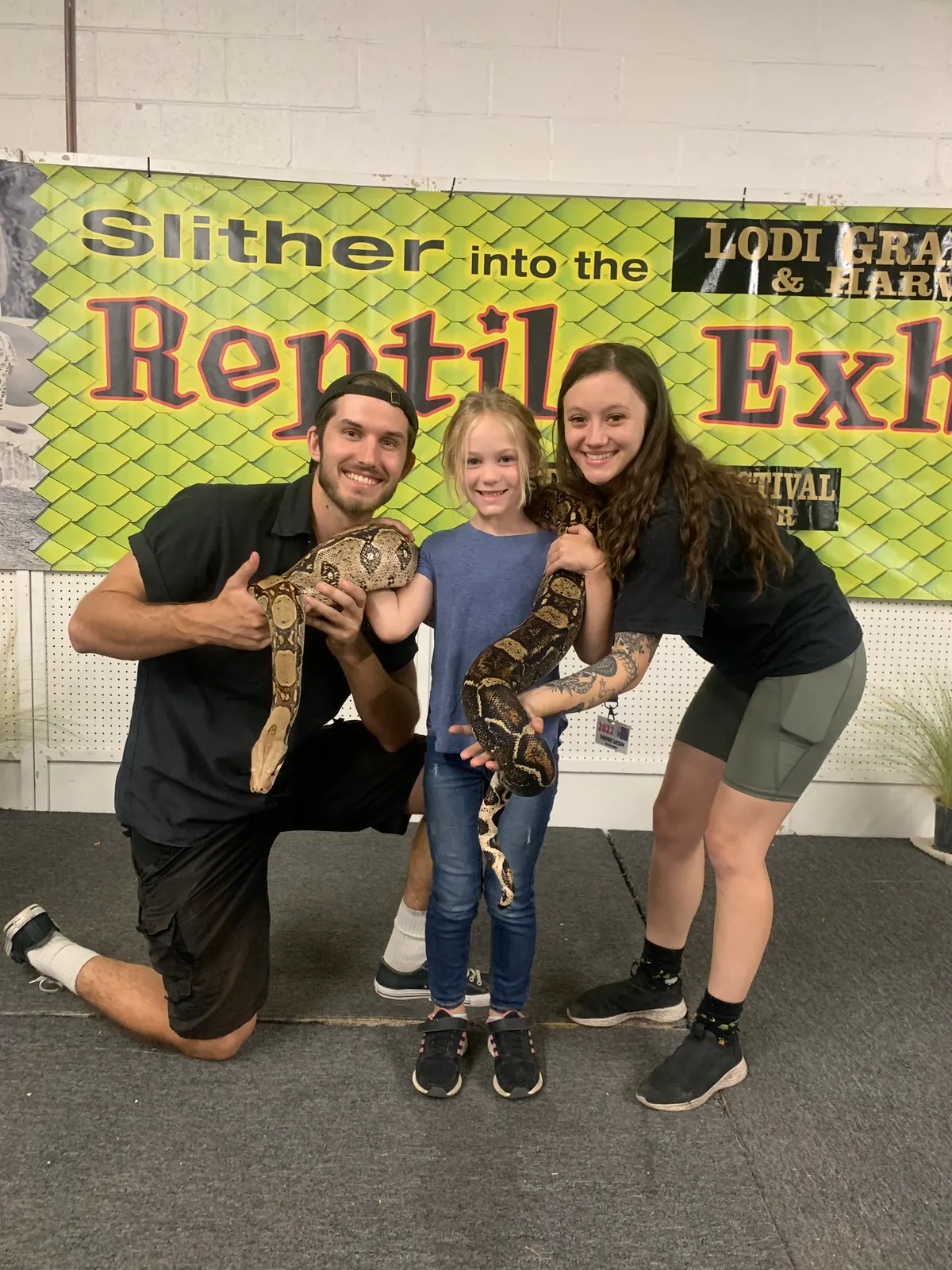 Tyler and Jasmyn with kids at the Slither into the Reptile Exhibit festival