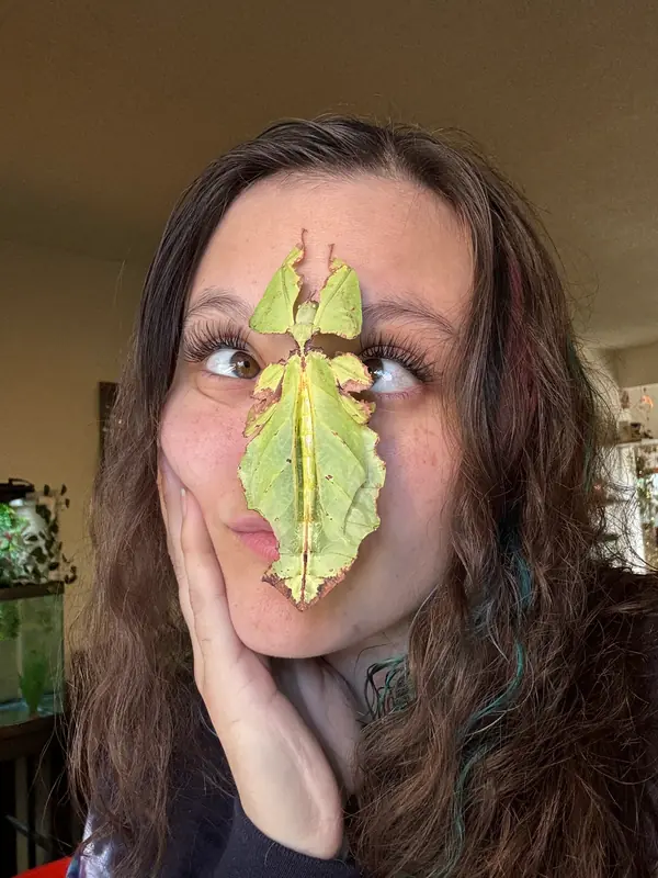 Jasmyn with a leaf insect on her face