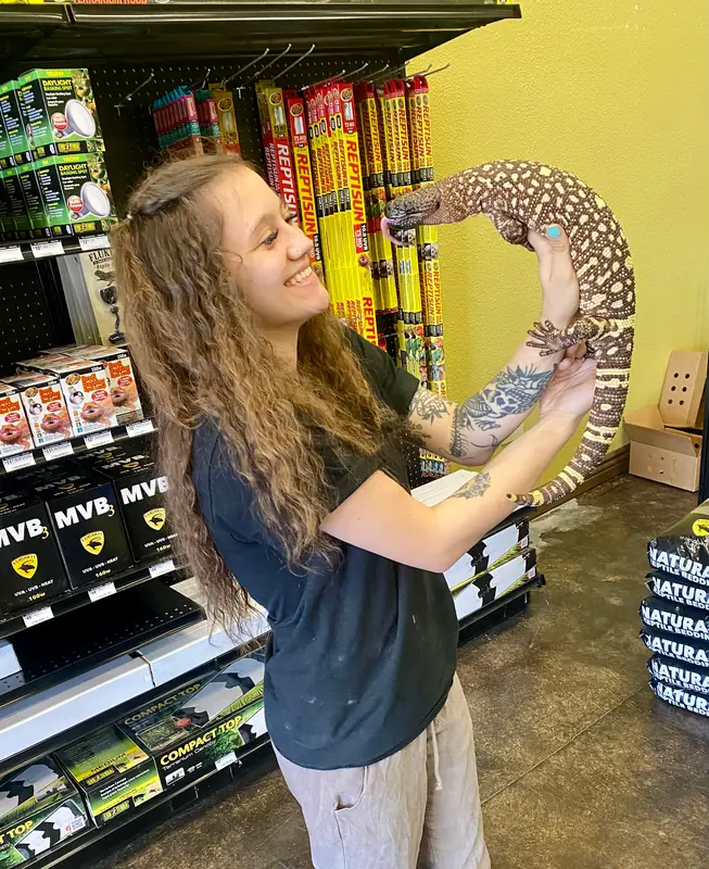 Jasmyn with a monitor in the shop aisle