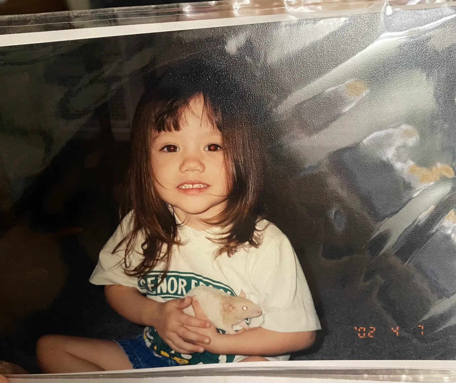 Jasmyn as a little kid, holding a hamster